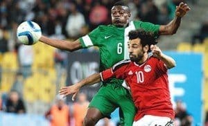 Egypt’s Mohamed Salah (right) and Nigeria’s Stanley Amuzie during their African Cup of Nations qualification match played at the Borg el-Arab Stadium in Alexandria...on Tuesday. Photo: AFP