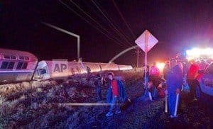 Emergency personnel work on a train that derailed near Dodge City, Kan., Monday, March 14, 2016. An Amtrak statement says the train was traveling from Los Angeles to Chicago early Monday when it derailed just after midnight. (Daniel Szczerba via AP)