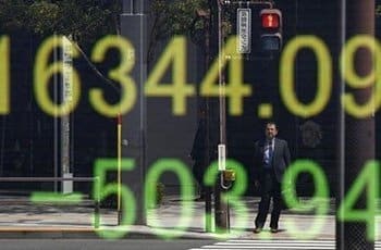 businessman is reflected in an electronic board