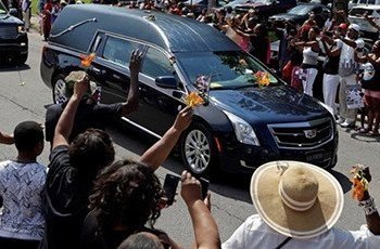 Well-wishers have been throwing flowers onto the hearse