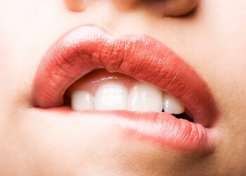 a woman biting lip in pain