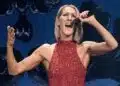 Celine Dion singing on stage during a live performance return.