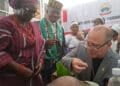 Canadian High Commissioner eating Ekiti pounded yam