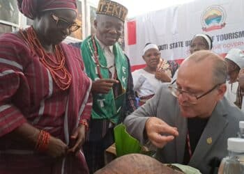 Canadian High Commissioner eating Ekiti pounded yam