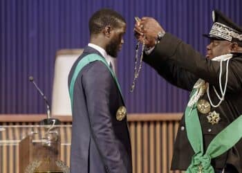 Bassirou Diomaye Faye (L) is sworn in as Senegal’s President at an exhibition centre in the new town of Diamniadio near the capital Dakar on April 2, 2024. (Photo by John WESSELS / AFP)