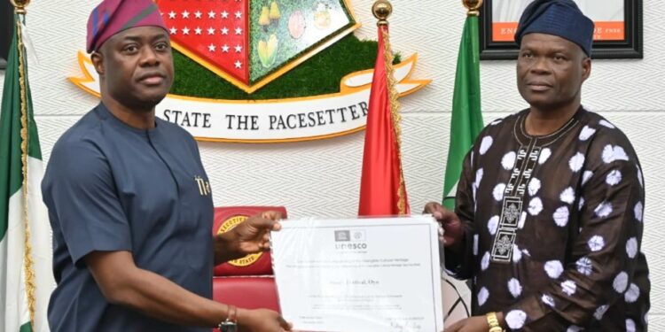 Oyo State governor, ‘Seyi Makinde (left); receiving the UNESCO Intangible Cultural Heritage Certificate for Sango Festival from Commissioner for Culture and Tourism, Dr Wasiu Olatubosun, during a State Executive Council meeting, held at Executive Chamber, Governor's Office, Secretariat, Ibadan.