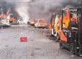 Smoke rises from torched vehicles during Eastern Cape violence over Nigerian king installation.