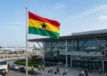 Ghana national flag flying at an international airport terminal.