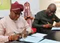 Construction workers and architects reviewing plans for the Ibadan Bower Tower redevelopment in Oyo State