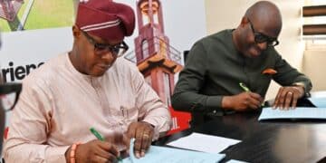 Construction workers and architects reviewing plans for the Ibadan Bower Tower redevelopment in Oyo State