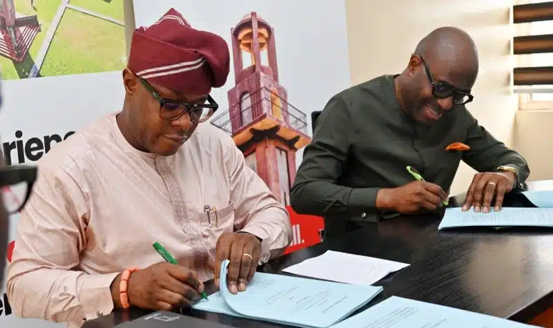Construction workers and architects reviewing plans for the Ibadan Bower Tower redevelopment in Oyo State