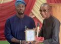 Oyo NUJ Chairman Akeem Abas speaking at the ASCOM oratorical contest podium to Mass Communication students.