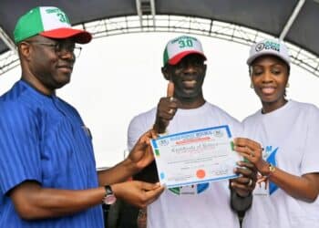 Governor Seyi Makinde speaking at the Allied Peoples Movement Oyo primary elections ahead of the Oyo State 2027 elections, with Bimbo Adekanmbi receiving his governorship certificate of return from APM party executives in Ibadan.