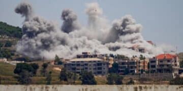 Smoke rising from building structures following intense Israeli strikes in Lebanon.