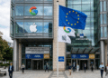 European Union flag standing outside Google apple headquarters representing Digital Markets Act AI regulation.