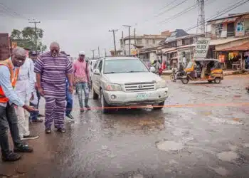 Hon Adedeji Olajide Odidiomo inspecting drainage structures during the road rehabilitation initiative.