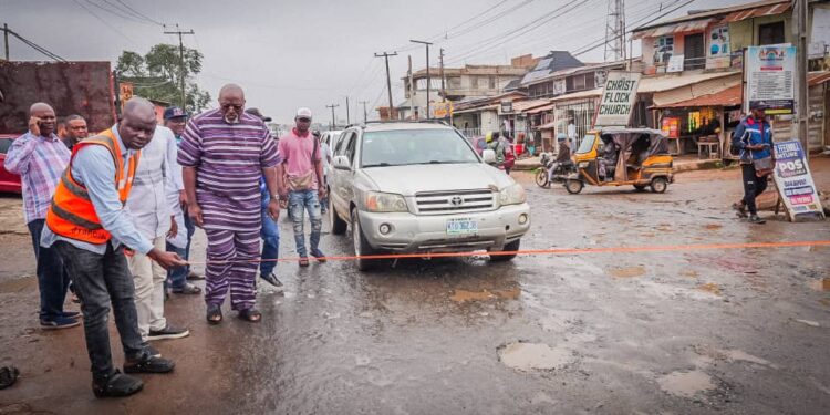 Hon Adedeji Olajide Odidiomo inspecting drainage structures during the road rehabilitation initiative.