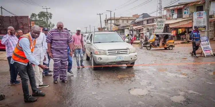 Hon Adedeji Olajide Odidiomo inspecting drainage structures during the road rehabilitation initiative.