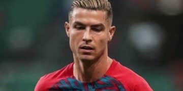 Cristiano Ronaldo in his Portugal national team jacket looking dramatically upward after leaving the training camp.