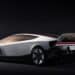 Futuristic silver Tesla Roadster concept hovering above a platform with rocket-like thrusters and dramatic red lighting.