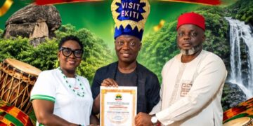 Wale Ojo-Lanre presenting official certification for the Gbagede Ule Ewa Festival to Emure-Ekiti delegation.